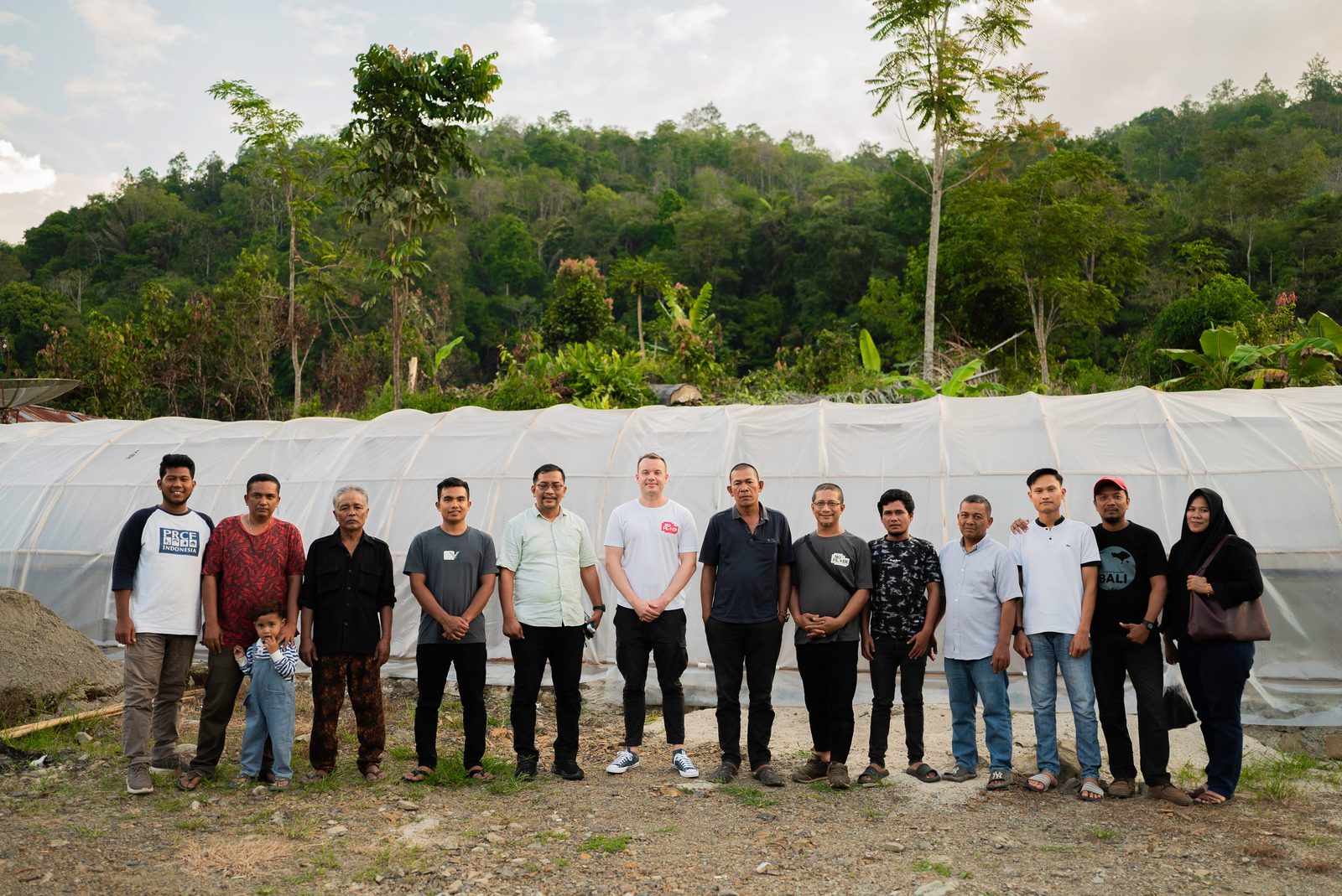 Komanja growers, PRCF and SRI members, with the NoFilter founder at the Batang Gadis drying house, the forest edge behind them
